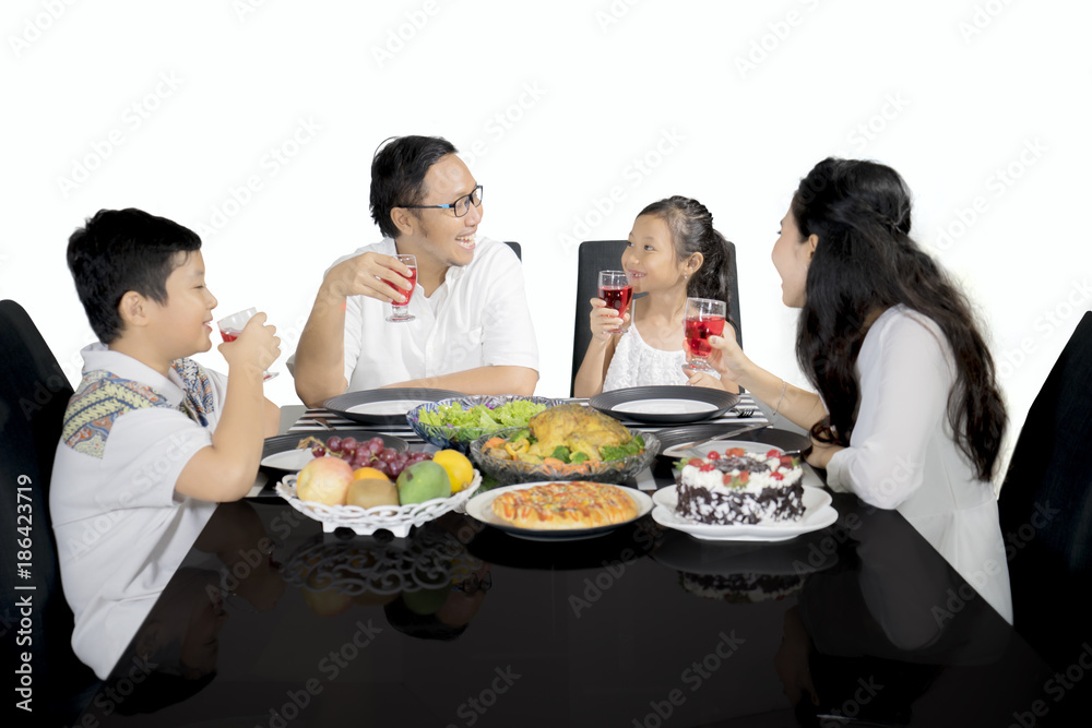 Family talking each other in the dining table