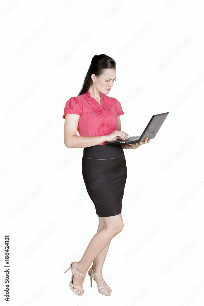 Confused entrepreneur working with a laptop on studio Confused entrepreneur working with a laptop on studio