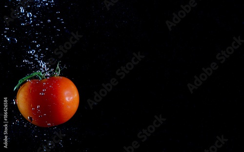 Tomato in the Water on black background