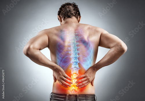 Lower back pain. Man holding his back in pain. Medical concept. photo