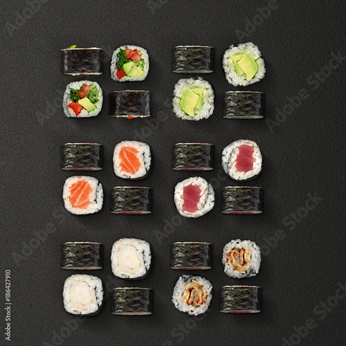 Japanese cuisine. Sushi rolls set over dark background.