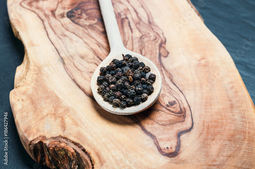 Black pepper on rustic wooden table with copy space