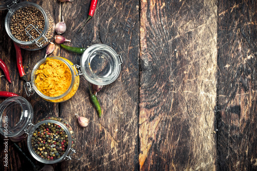 Various spices in glass jars.