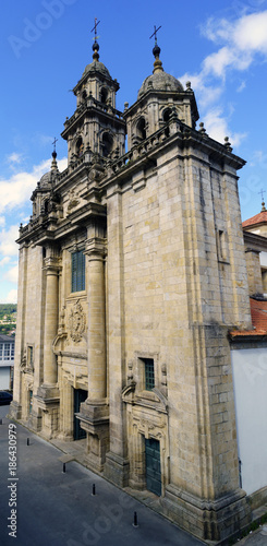 Aerial view of the facade of the parish church of Santiago in neoclassical style with baroque reminiscences built in granite stone in a village called Pontedeume in La Coruna, Spain. With a blue sky photo