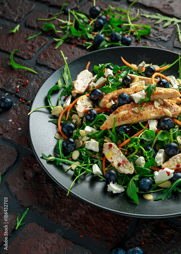 Fresh Chicken salad with Blueberries, feta, carrots, nuts and green vegetables. healthy food concept
