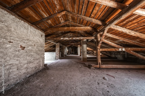 Creepy attic interior at abandoned building photo