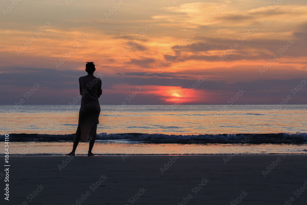 beautiful woman
Standing alone
Watching the sunset on the beach.
Evening time
Silhouette style