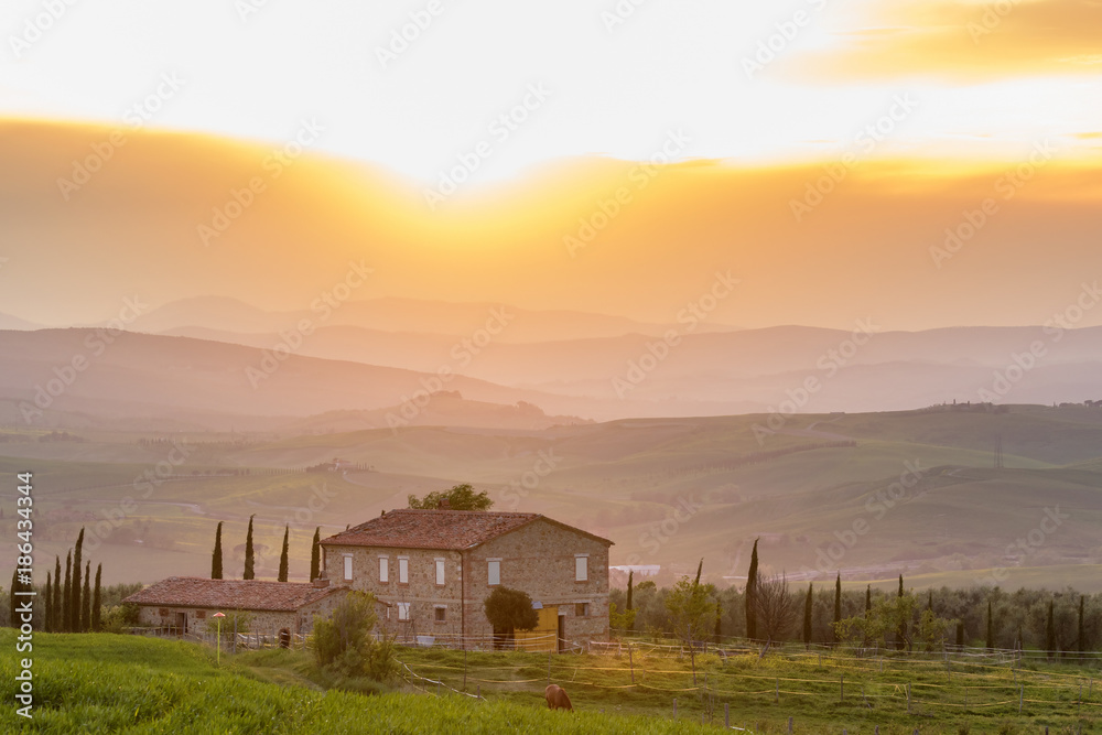 Farmhouse in the Tuscan rural landscape at sunset Farmhouse in the Tuscan rural landscape at sunset