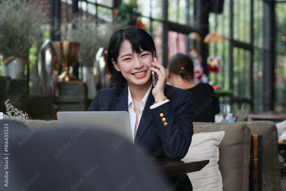 Asian business girl working and drinking coffee in cafe Asian business girl working and drinking coffee in cafe