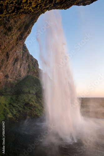 Sunset at the back of Seljalandsfoss waterfall in Iceland