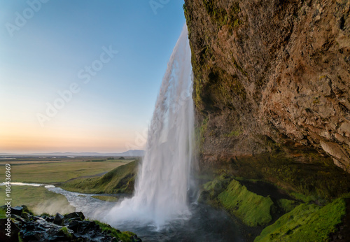 Sunset at the back of Seljalandsfoss waterfall in Iceland