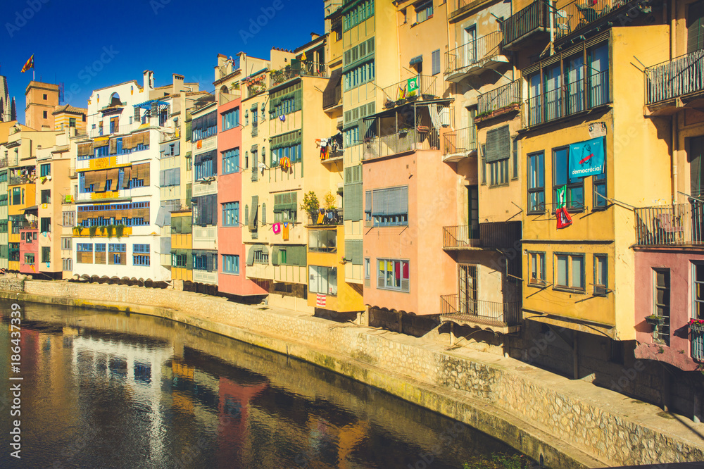 Colorful facades of houses on river bank in Girona