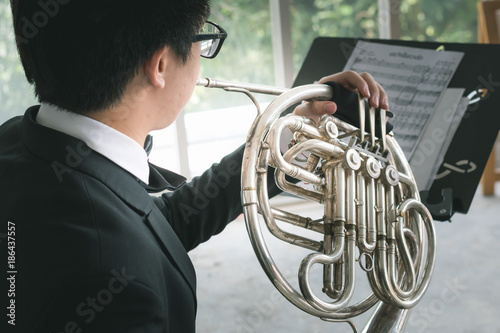 professional musical instrument concept : musician artist playing metal french horn