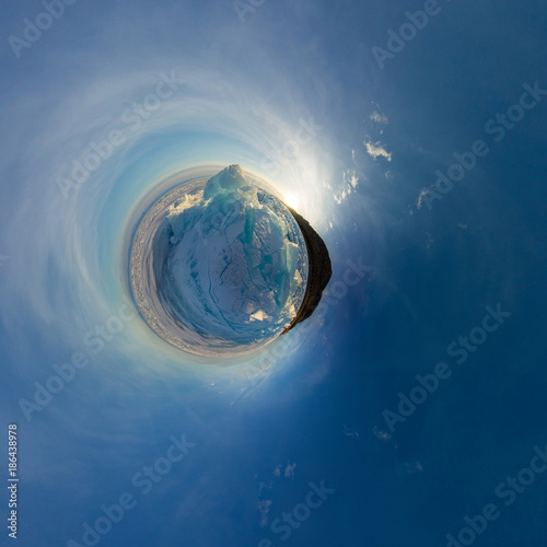 blue hummocks of the ice Baikal at sunset from Olkhon. Spherical 360 panorama little planet