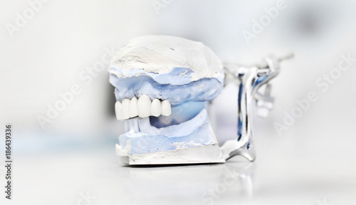 Dental articulator isolated on white background, dentist technical tools photo