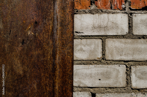 Metal door and old brick wall. Old brick wall texture background. Rusty metal door