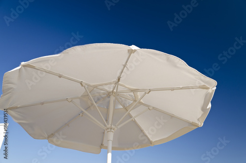 Beach umbrella against the blue clear sky on the beach