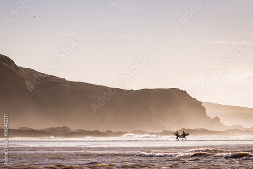 Surfers leaving the ocean