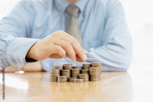 Close-up Of A Businessman Making Stack Of Coins
