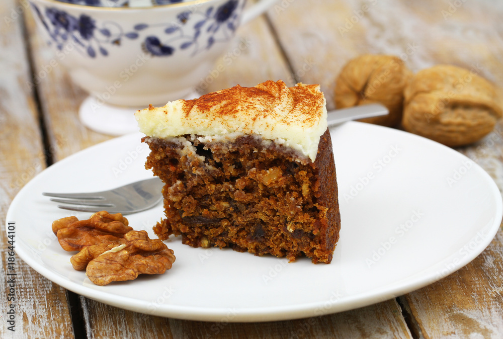 Slice of delicious carrot cake with walnuts
