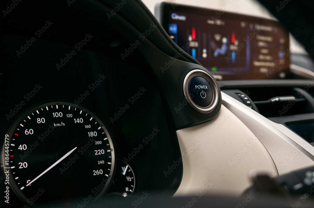 Start and stop button. Speedometer and climate control display