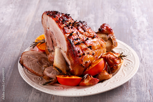 Glazed ham with apples and oranges photo