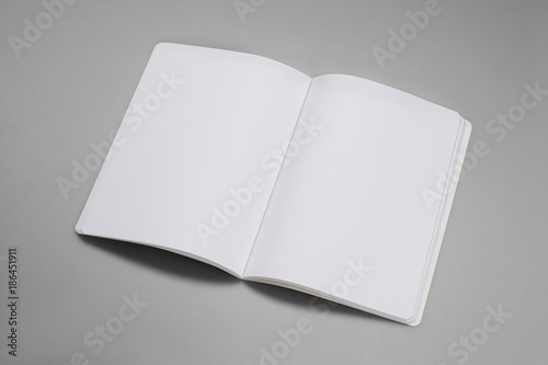 Mock-up magazine, book or catalog on gray table. Blank page or notepad on solid background. Blank page or notepad for mockups or simulations.