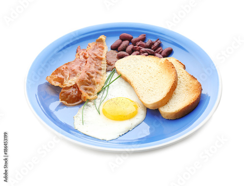Plate with tasty toasts, fried egg and bacon, isolated on white