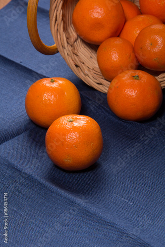 Ripe tangerines on a blue linen napkin