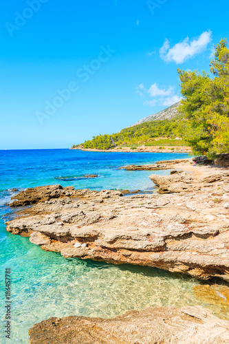 View of small bay with beach among rocks near famous cape Zlatni Rat in Bol town, Brac island, Croatia