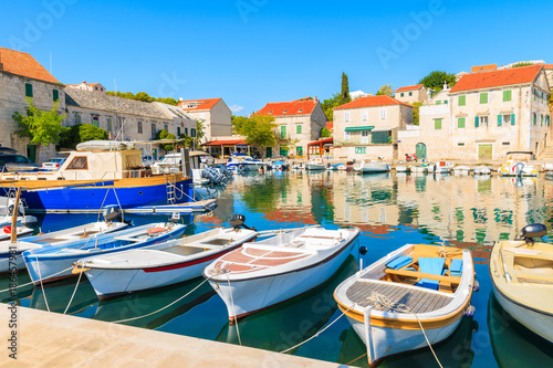 Row of fishing boats anchoring in Sumartin port on Brac island, Croatia