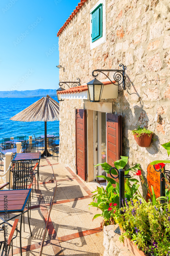 Fototapeta premium Small coastal restaurant on beach in Bol town, Brac island, Croatia