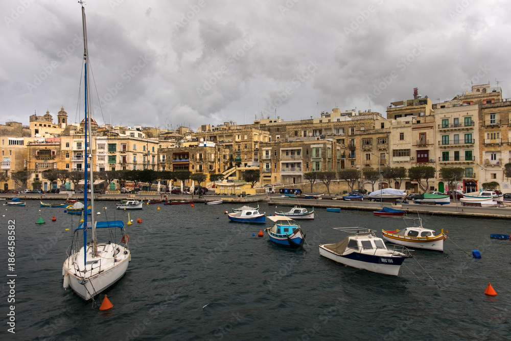 Birgu. Kalkara. Bormla. Boat mooring. Clouds over Valletta. Malta.