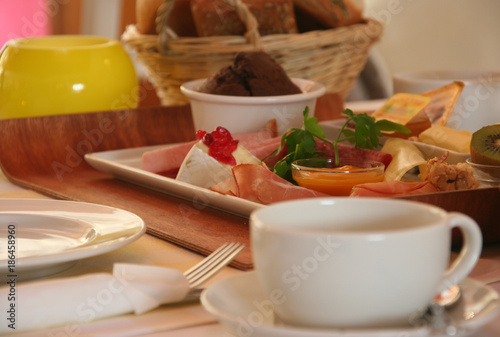 Frühstück mit Tasse, Brötchen, Croissant, Wust und Käse.  photo