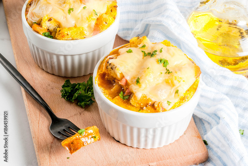 Homemade italian bread casserole strata with cheese, egg and ham, white background copy space photo