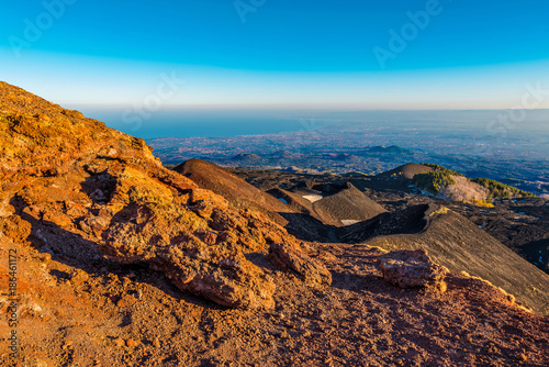 Mt. Etna Volcano, Monti Silvestri (Silvestri Craters), at sunset, with the city of Catania in the background