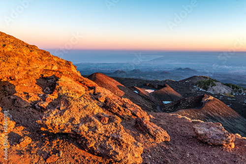 Mt. Etna Volcano, Monti Silvestri (Silvestri Craters), at sunset, with the city of Catania in the background, Sicily, Italy