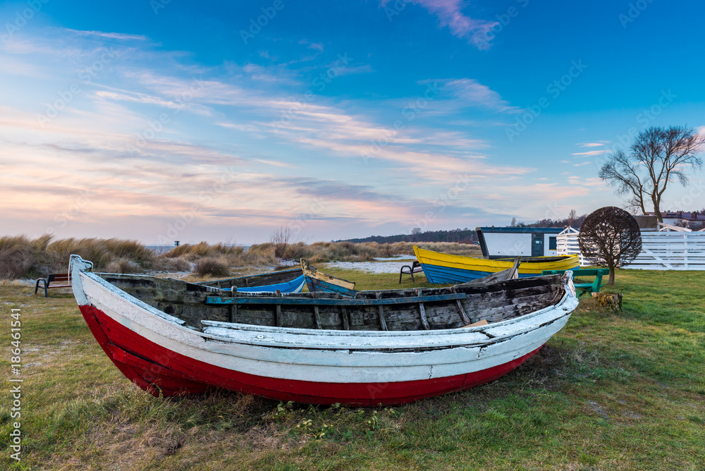 Obraz premium Old fishing boat on the shore of Baltic Sea in Kuznica village on Hel Peninsula in Poland.