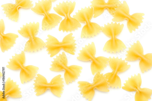 Raw farfalle top view isolated on white background a lot of dry pasta pieces.