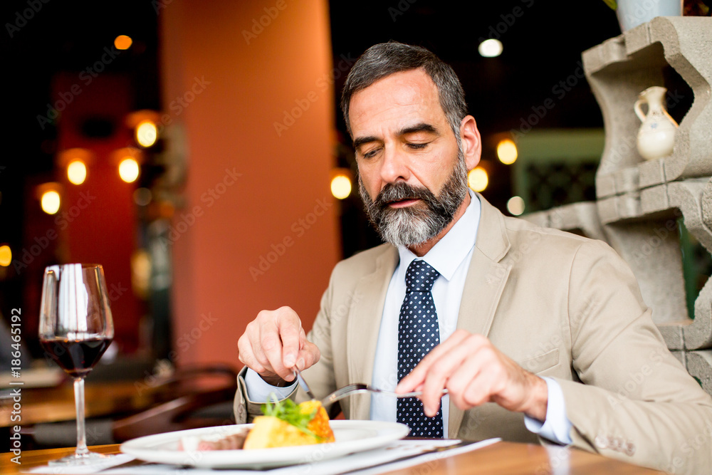 Senior man eating lunch in restaurant
