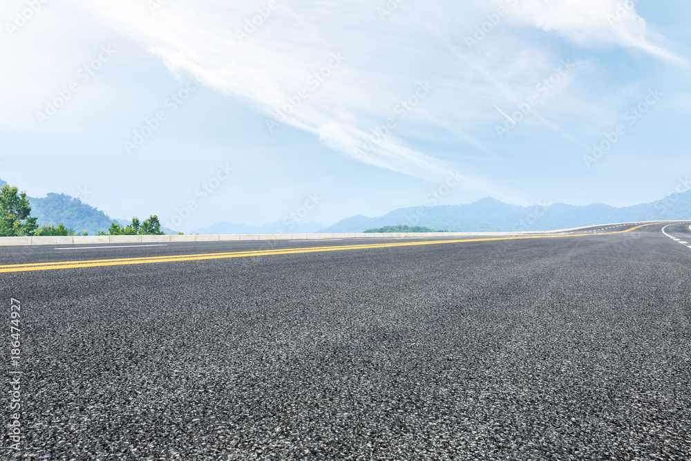 country road and mountains natural landscape in the summer country road and mountains natural landscape in the summer