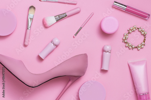 Layflat image of pink womans fashion and cosmetics products.