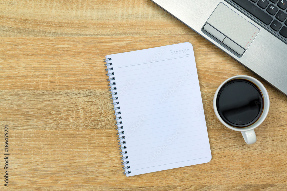 Laptop computer or notebook, note and cup of coffee on working table with copy space top view. Laptop computer or notebook, note and cup of coffee on working table with copy space top view.