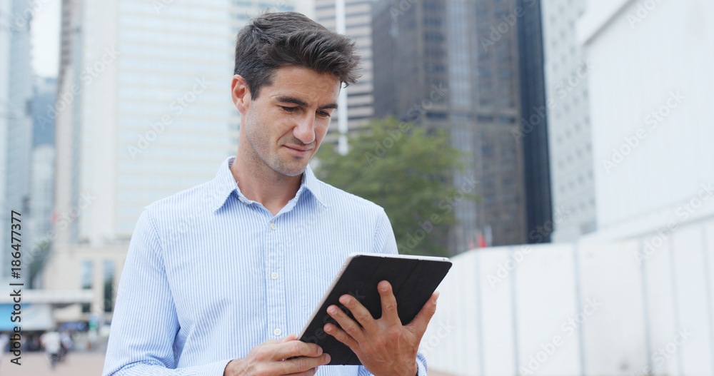 Businessman hold with tablet computer in city Businessman hold with tablet computer in city