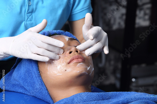 Anti Aging Facial treatment with Cream massage on woman face
