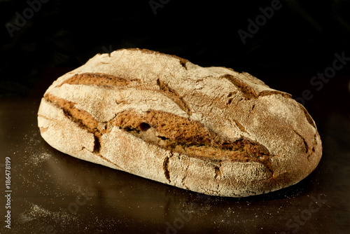 Fresh German sourdough rye bread on dark background