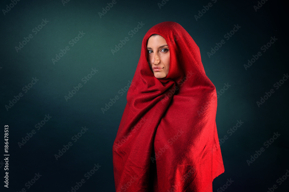 Caucasian Girl covered in a red poncho Caucasian Girl covered in a red poncho