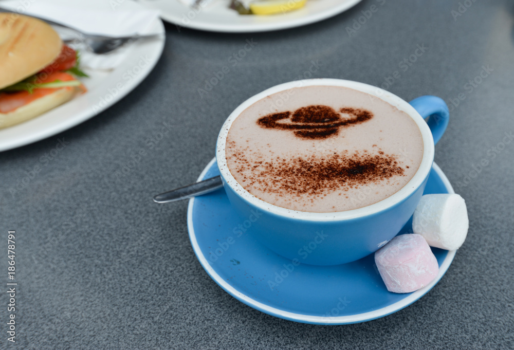 Cup of coffee with cream foam as Saturn Cup of coffee with cream foam as Saturn