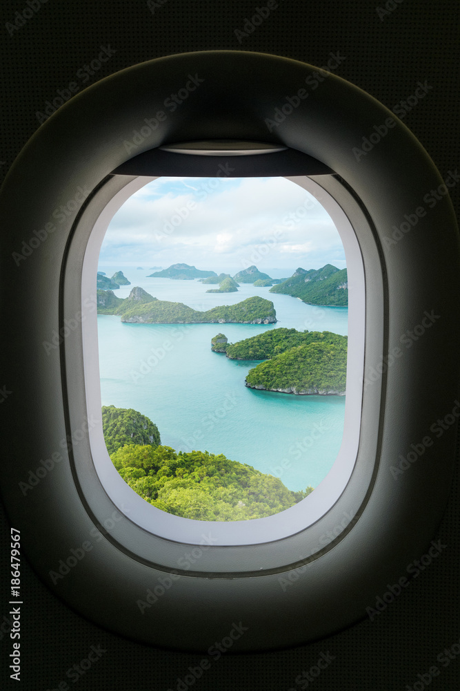 The window of airplane with travel destination attraction.