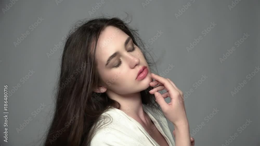 Slow motion video portrait of beauty young brunette woman with green eyes and streaming hair Slow motion video portrait of beauty young brunette woman with green eyes and streaming hair